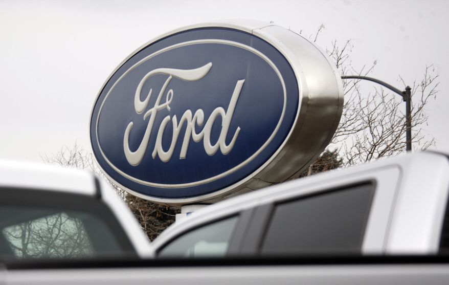 Ford Motor Co.'s sign hangs over the lot at a Ford dealership in Littleton, Colo., on Sunday, Feb. 28, 2010. (AP Photo/David Zalubowski)