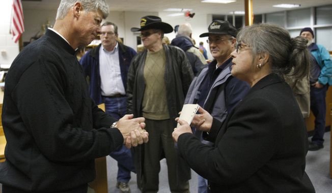 Rep. Bart Stupak (left), Michigan Democrat, speaks with Elin Richardson of Rapids City, Mich., after a town-hall meeting in Tawas City, Mich., on Monday, March 8, 2010. (AP Photo/Carlos Osorio)