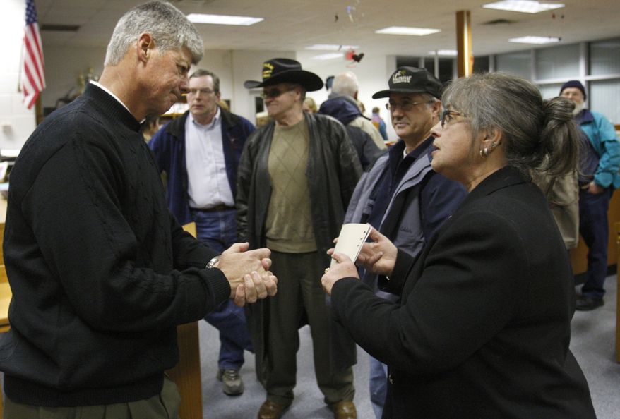 Rep. Bart Stupak (left), Michigan Democrat, speaks with Elin Richardson of Rapids City, Mich., after a town-hall meeting in Tawas City, Mich., on Monday, March 8, 2010. (AP Photo/Carlos Osorio)