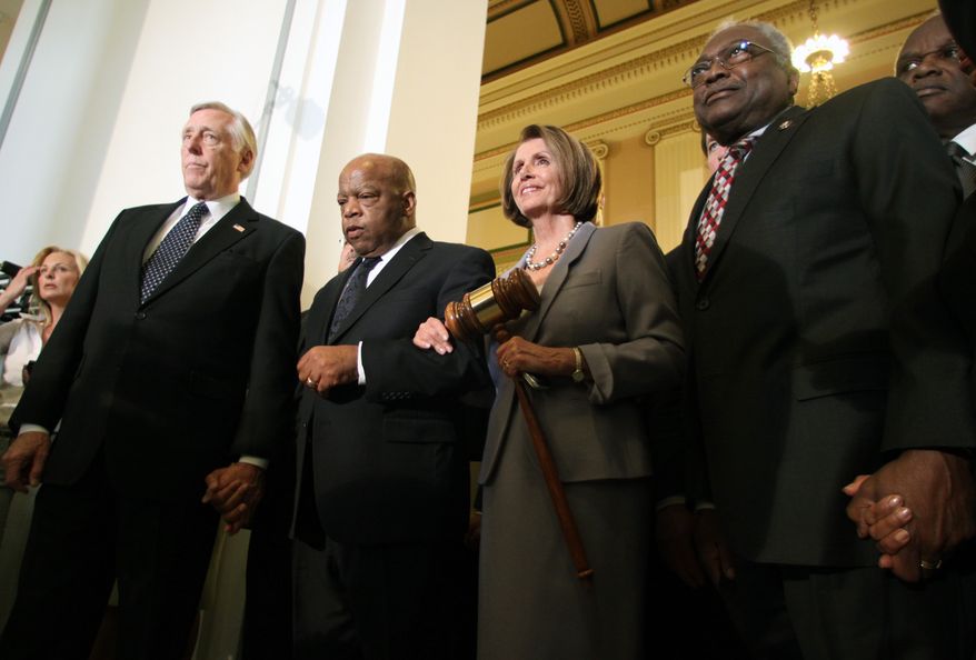 House Speaker Nancy Pelosi holds a large gavel Sunday on Capitol Hill as she emerges from a Democratic Caucus meeting with (from left) Reps. Steny Hoyer, John Lewis and Jim Clyburn. (Associated Press)