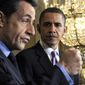 French President Nicolas Sarkozy (left) speaks as President Barack Obama listens Tuesday in the East Room of the White House. (Associated Press)