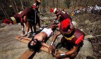 Actors reenact Jesus Christ&#39;s crucifixion on Good Friday, in Gauhati, India, Friday, April 2, 2010. Good Friday is observed as a day of mourning in memory of the crucifixion of Christ. (AP Photo/Anupam Nath)