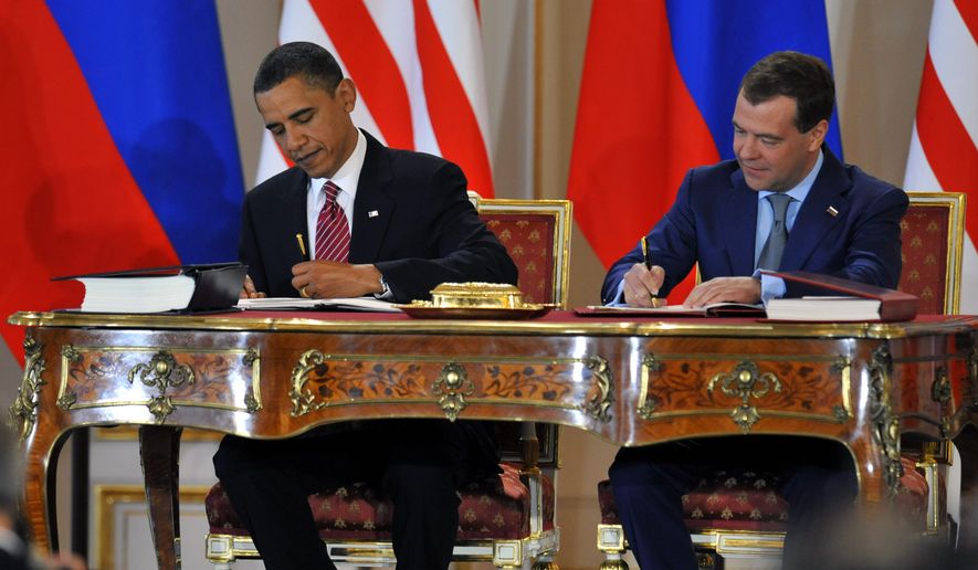 President Obama and his Russian counterpart Dmitry Medvedev (right) sign the &#x27;New START&#x27; nuclear arms reduction treaty at Prague Castle on April 8, 2010. (Associated Press) **FILE** 