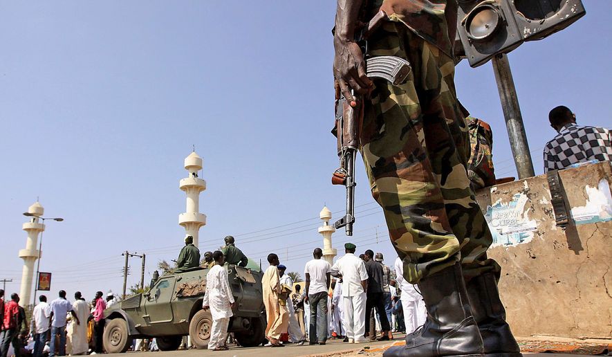 A Nigerian soldier stands guard outside the central mosque in Jos, Nigeria, in January after violence resulted in the deaths of both Christians and Muslims. The U.S. Commission on International Religious Freedom puts Nigeria in the company of China, Iran and other top violators of religious freedom. (File photo, Associated Press)