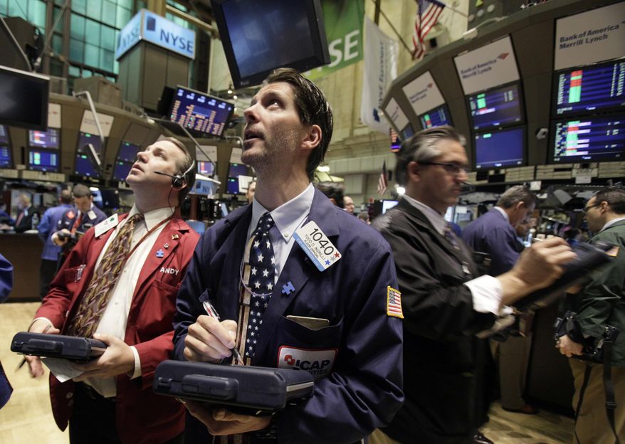 Traders work on the floor of the New York Stock Exchange Friday, May 7, 2010, a day after a dramatic tumble in the stocks. (AP Photo/Richard Drew)