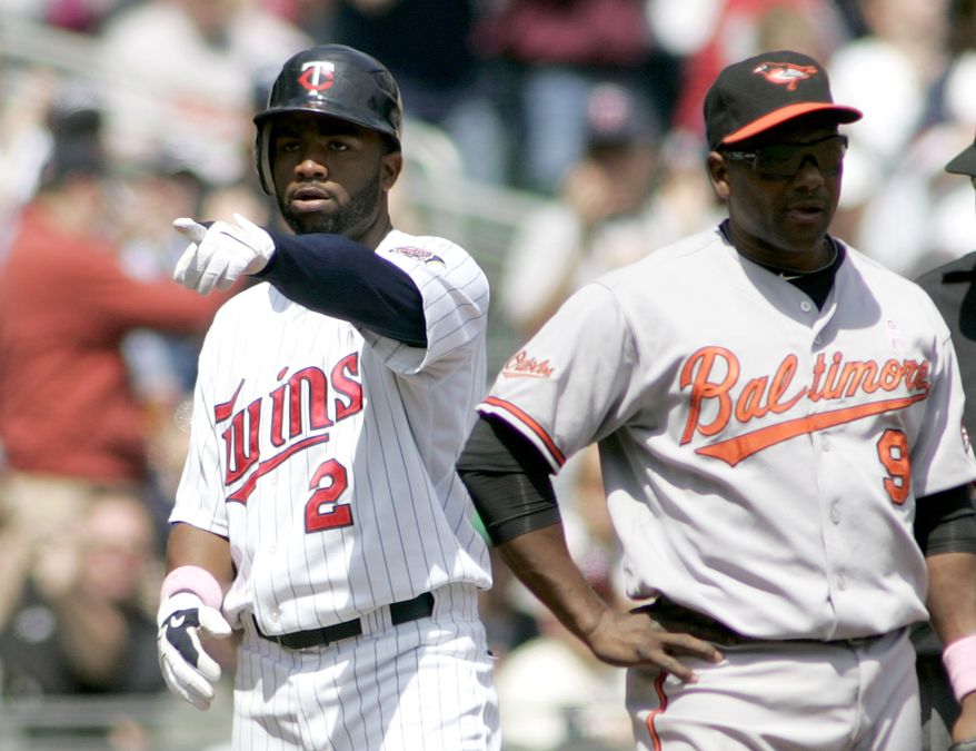 ASSOCIATED PRESS Minnesota Twin Denard Span, left, points to teammates after stealing third base as Baltimore Orioles Miguel Tejada stands next to him in the fourth inning of a baseball game Sunday, May 9, 2010, in Minneapolis.