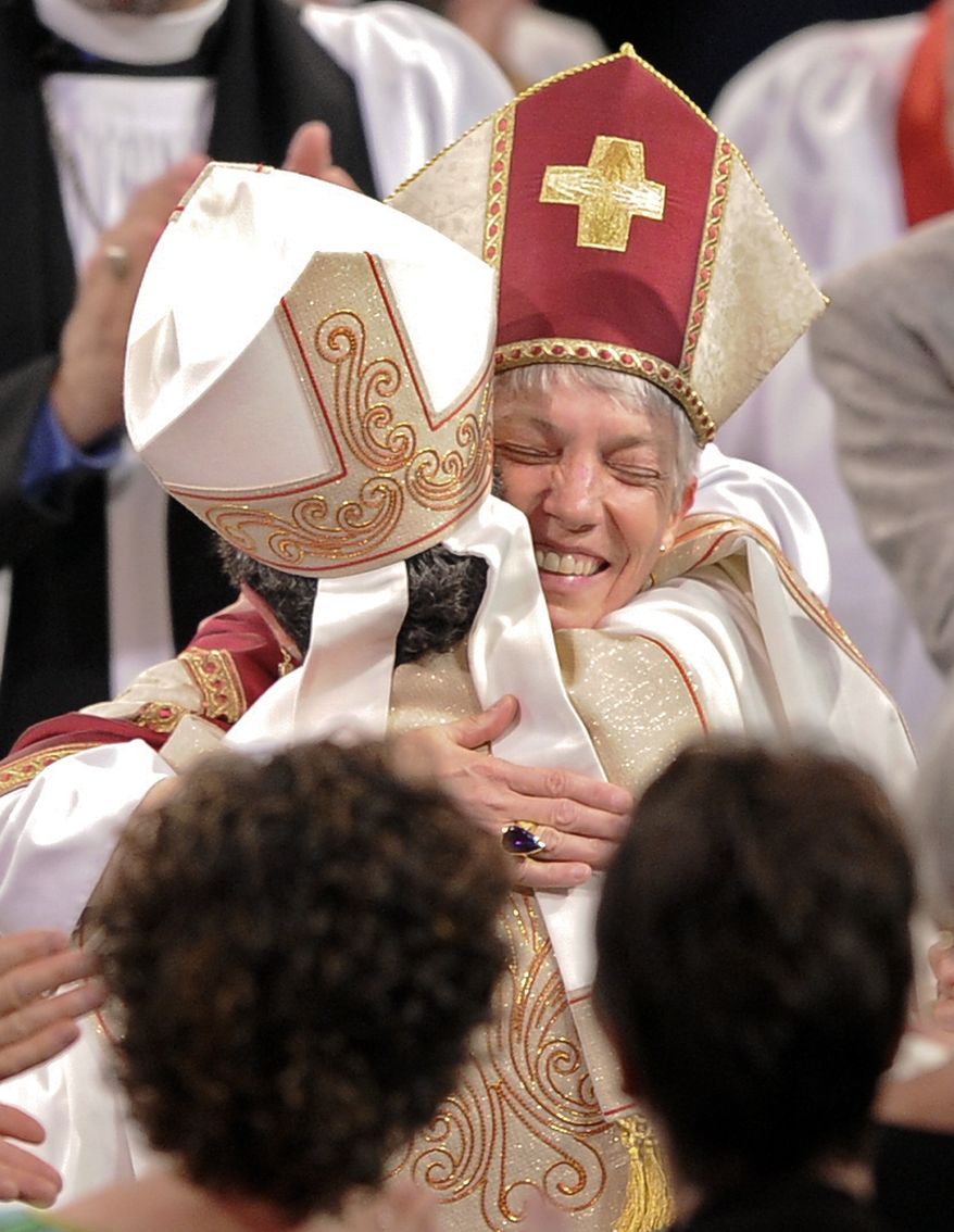 Rev. Canon Diane M. Jardine Bruce, left, and Rev. Canon Mary Glasspool congratulate each other after their ordination and consecration ceremony, Saturday, May 15, 2010, in Long Beach, Calif. Seven years after the Episcopal Church caused an uproar by consecrating its first openly gay bishop, it has done the same thing again _ only this time with a woman. Glasspool, of Baltimore, was ordained and consecrated on Saturday, making her the second openly gay bishop in church history and one of the first two female bishops in the Diocese of Los Angeles' 114-year history. (AP Photo/Mark J. Terrill)