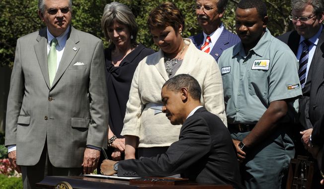 **FILE** President Obama signs a presidential memorandum outlining the next steps for cleaner and more efficient vehicles on May 21, 2010, in the Rose Garden of the White House in Washington. From left: Transportation Secretary Ray LaHood, White House energy czar Carol Browner, EPA Administrator Lisa Jackson, Navistar Chief Executive Officer Daniel Ustian, Waste Management driver Anthony Dunkley and Daimler Trucks North America Chief Executive Officer Martin Daum. (Associated Press)