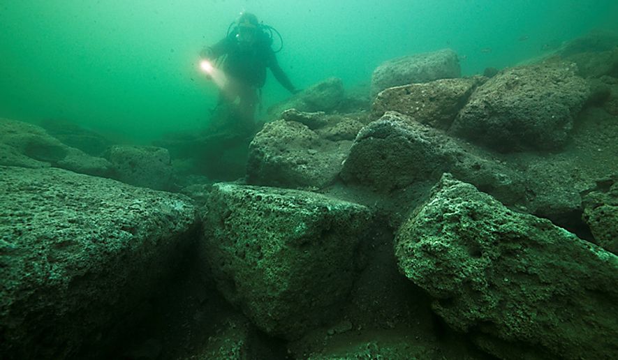 In this photo released by Franck Goddio/Hilti Foundation, a diver inspects limestone blocks that form part of the ruins of the Temple of Isis on the royal island of Antirhodos, on the seabed of the harbor of Alexandria, Egypt, Tuesday, May 25, 2010. An international team of archaeological divers led by French underwater archaeologist Franck Goddio is using advanced technology to explore the submerged ruins of a palace and temple complex from where Queen Cleopatra ruled, painstakingly excavating one of the richest underwater archaeological sites in the world and retrieving stunning artifacts from the last dynasty to rule over ancient Egypt before the Roman Empire annexed it in 30 B.C. (AP Photo/Franck Goddio & Hilti Foundation, Christoph Gerigk) EDITORIAL USE ONLY, NO SALES, MANDATORY CREDIT