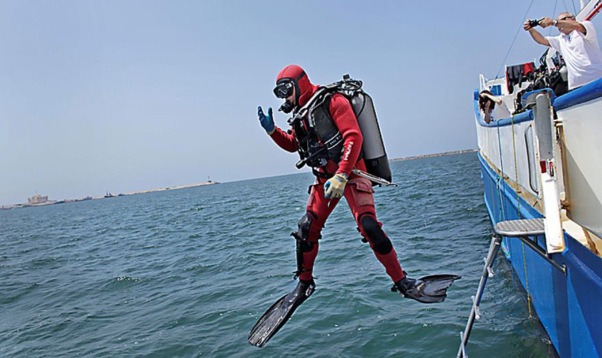 An archaeological diver plunges into the sea from the Princess Duda research boat anchored in the harbor of Alexandria, Egypt, Tuesday, May 25, 2010. An international team of archaeological divers led by French underwater archaeologist Franck Goddio is using advanced technology to explore the submerged ruins of a palace and temple complex from where Queen Cleopatra ruled, painstakingly excavating one of the richest underwater archaeological sites in the world and retrieving stunning artifacts from the last dynasty to rule over ancient Egypt before the Roman Empire annexed it in 30 B.C. (AP Photo/Ben Curtis)