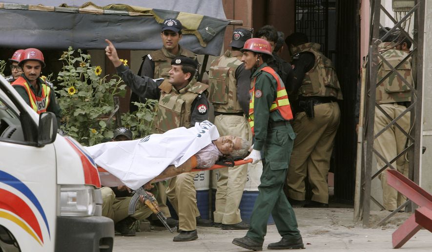 An injured Pakistani worshipper is carried from the scene after an attack by suspected Islamist militants, outside Garhi Shahu mosque in Lahore, Pakistan, Friday, May 28, 2010. Suspected Islamist militants attacked two mosques, Garhi Shahu and Model Town, packed with some hundreds of people from a minority sect in eastern Pakistan on Friday, laying siege to Garhi Shahu in a standoff with police, when an unknown number of people died. (AP Photo/K.M. Chuadary)