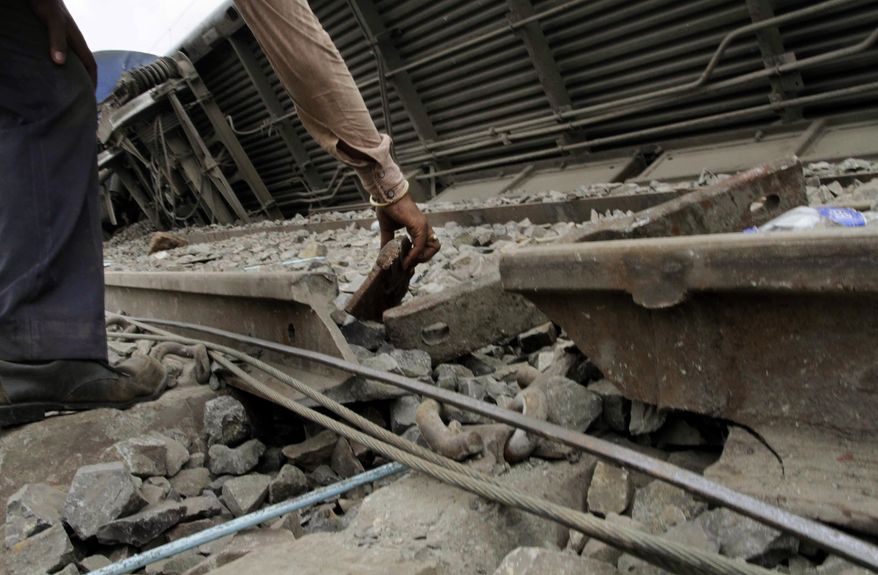 An Indian railroad employee looks at the broken rail track that is believed to be the cause of a train accident that killed 145 in West Bengal state, about 90 miles west of Calcutta, India, on Friday, May 28, 2010. (AP Photo/Bikas Das)