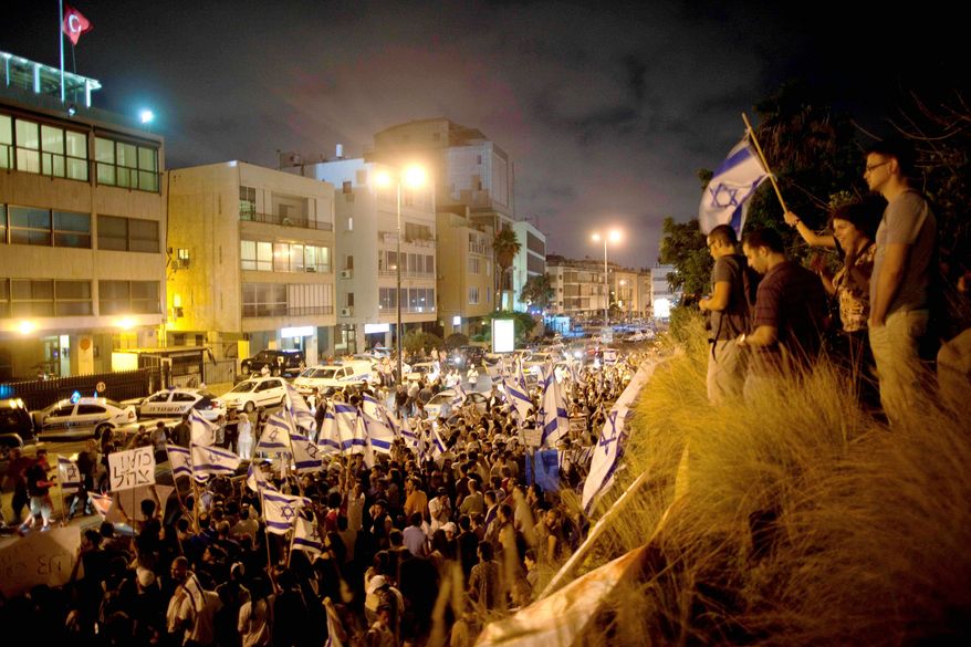 Hundreds of Israelis wave Israeli flags during a demonstration outside the Turkish Embassy in Tel Aviv on Monday in support of Israel after a deadly raid by Israel's navy on an aid flotilla bound for the blockaded Gaza Strip. (Associated Press)