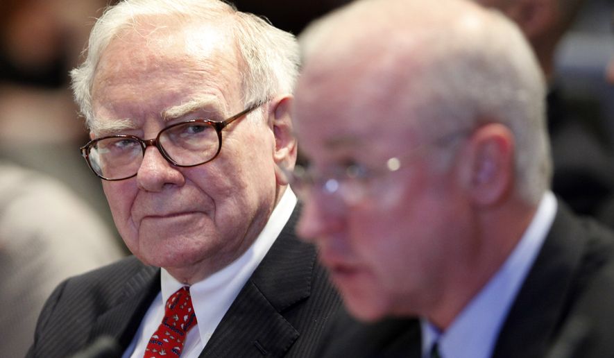 Warren Buffett, left, Chairman and CEO of Berkshire Hathaway, listens to the testimony of Raymond McDaniel, Chairman and CEO of Moody's Investor Services, at a hearing of the Financial Crisis Inquiry Commission, Wednesday, June 2, 2010, in New York. (AP Photo/Mark Lennihan)