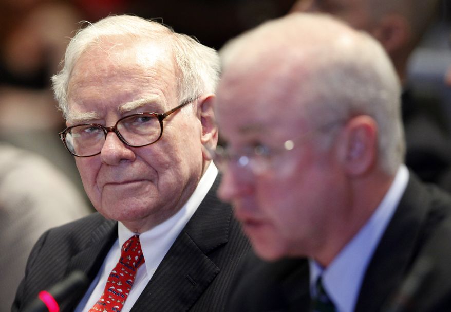 Warren Buffett, left, Chairman and CEO of Berkshire Hathaway, listens to the testimony of Raymond McDaniel, Chairman and CEO of Moody's Investor Services, at a hearing of the Financial Crisis Inquiry Commission, Wednesday, June 2, 2010, in New York. (AP Photo/Mark Lennihan)