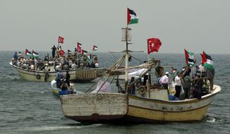 **FILE** Palestinians in fishing boats decorated with Turkish and Palestinian flags hold a pro-Turkey demonstration in the sea off the shore of Gaza City on June 3, 2010. Israel on Thursday rejected calls from the United Nations and others for an international investigation of its deadly raid on a Gaza-bound aid flotilla but left the door open to foreign involvement. (Associated Press)