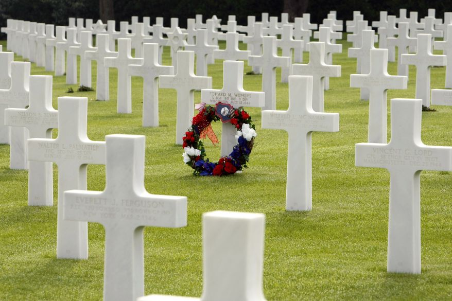 A wreath marks the grave of U.S. soldier Edward M. Withers of Wisconsin at the Colleville U.S. cemetery in northwestern France's Normandy region on Sunday, June 6, 2010, the 66th anniversary of D-Day. (AP Photo/Remy de la Mauviniere)