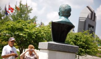 Wayburn Norfleet and Norma Stover, visiting from Indiana, take pictures of the Josef Stalin bust at National D-Day Memorial in Bedford, Va. The controversial bust was installed in time for Sunday&#39;s 66th anniversary of the World War II invasion of Normandy. (Associated Press)