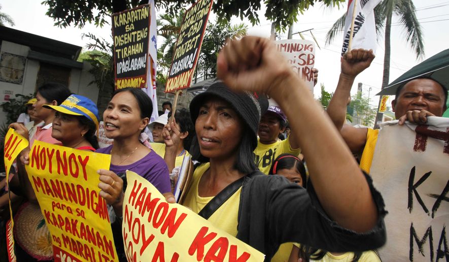 Protesters gather outside the residence of Philippine President-elect Benigno "Noynoy" Aquino III on Times Street in the Manila suburb of Quezon City on Tuesday, June 8, 2010, to call his attention to the demolition of their homes allegedly carried out by the administration of outgoing President Gloria Macapagal Arroyo. (AP Photo/Bullit Marquez)