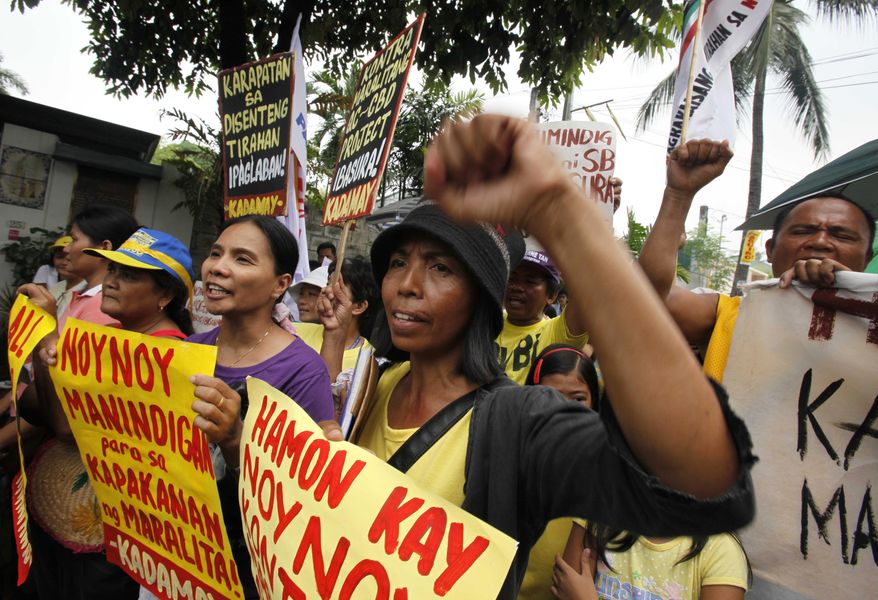 Protesters gather outside the residence of Philippine President-elect Benigno "Noynoy" Aquino III on Times Street in the Manila suburb of Quezon City on Tuesday, June 8, 2010, to call his attention to the demolition of their homes allegedly carried out by the administration of outgoing President Gloria Macapagal Arroyo. (AP Photo/Bullit Marquez)