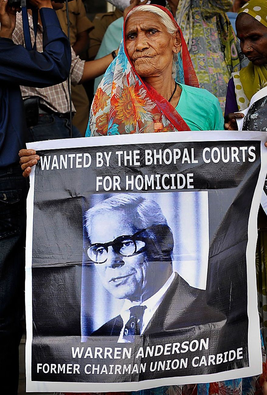 An elderly survivor holds a poster of Warren Anderson, the head of Union Carbide Corp. at the time of the gas leak, as she waits for the verdict in the premises of Bhopal court in Bhopal, India, on June 7, 2010. The court convicted seven former senior employees of Union Carbide&#39;s Indian subsidiary of &quot;death by negligence&quot; for their roles in the Bhopal gas tragedy that left an estimated 15,000 people dead more than a quarter century ago in the world&#39;s worst industrial disaster. (Associated Press)