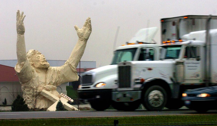 A Nov. 17, 2004 file photo shows traffic on I-75 just north of the Monroe, Ohio, going by a six-story-high statue of Jesus under construction at the Solid Rock Church Nov. 17, 2004. The 62-foot-tall statue made of plastic foam and fiberglass over a steel frame was stuck by lightning and destroyed Monday, June 14, 2010. (AP Photo/The Enquirer, Glenn Hartong/file)