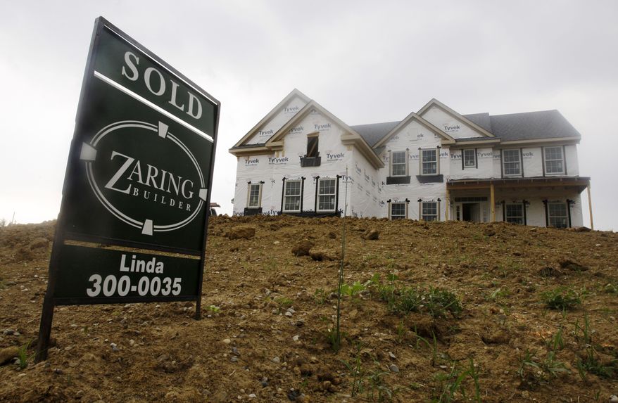 A "sold" sign is posted outside a new house under construction in Cincinnati on Wednesday, June 2, 2010. (AP Photo/Al Behrman)