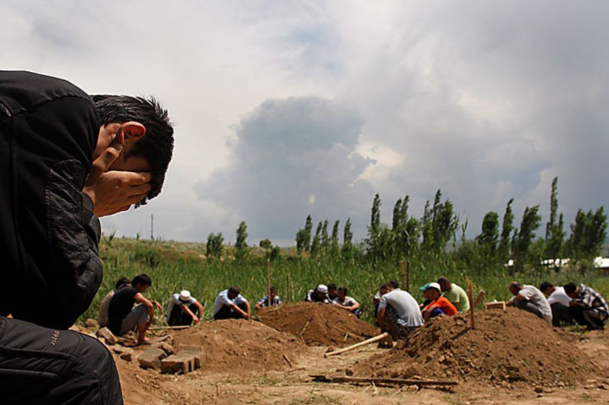 Uzbek men pray during a funeral for victims of ethnic rioting between Kyrgyz and ethnic Uzbeks in the southern Kyrgyz city of Osh on Wednesday, June 16, 2010. The official death count from the past week of violence rose to 189 on Wednesday, with 1,910 wounded, the Health Ministry said. Kyrgyzstan is observing three days of mourning for the victims of the recent mass-scale riots in the republic's southern regions. (AP Photo/Sergei Grits)