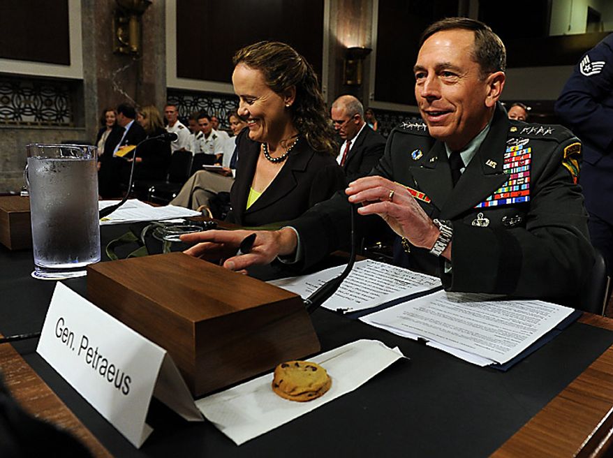 Army Gen. David H. Petraeus, commander, U.S. Central Command, prepares to testify before the Senate Armed Services Committee on the situation in Afghanistan on Capitol Hill in Washington on June 16, 2010. The committee gave him a few cookies after the hearing was continued from Tuesday when Gen. Petraeus slumped briefly during testimony, which aides blamed on dehydration and jet lag. At left is Michele Flournoy, undersecretary of defense for policy. (UPI/Roger L. Wollenberg)