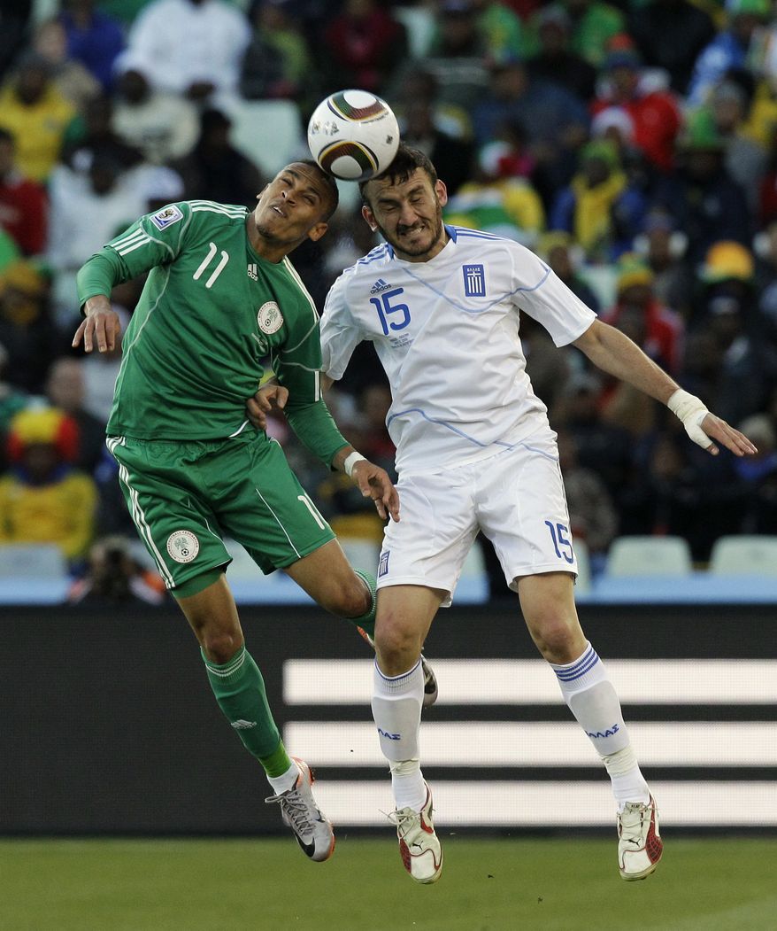 Greece&#x27;s Vassilis Torosidis, right, and Nigeria&#x27;s Peter Odemwingie, left, head the ball during the World Cup Group B soccer match between Greece and Nigeria at Free State Stadium in Bloemfontein, South Africa, Thursday, June 17, 2010. (AP Photo/Rick Bowmer)