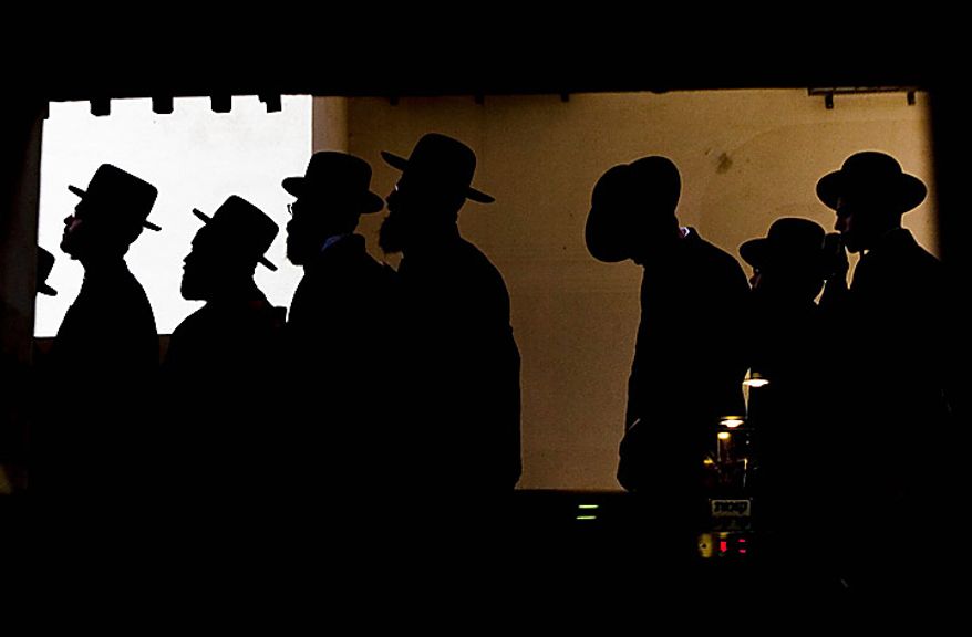 Ultra-Orthodox Jewish men gather in Bnei Brak, Israel, on Thursday, June 17, 2010, during a demonstration to protest an Israeli Supreme Court ruling forcing the integration of a religious girls school. Tens of thousands of black-clad men staged mass demonstrations on Thursday in Beni Brak and Jerusalem. (AP Photo/Ariel Schalit)