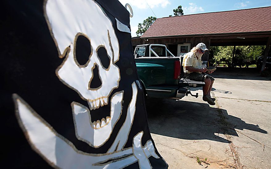 Boat captain Brent "Hollywood" Shaver sits on the back of his pickup truck at his home in Orange Beach, Ala., and tries to decide if he's going hunting Thursday, June 10, 2010. Shaver, a long time charter boat operator, is shutting down his inshore fishing business because of the gulf oil spill. (AP Photo/Dave Martin)