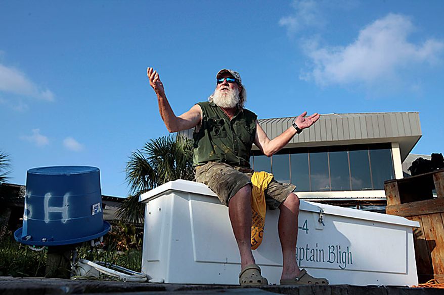 Boat captain Brent "Hollywood" Shaver sits on the dock at Cotton Bayou in Orange Beach, Ala., Thursday, June 10, 2010. Shaver, a long time charter boat operator, is shutting down his inshore fishing business because of the gulf oil spill. (AP Photo/Dave Martin)