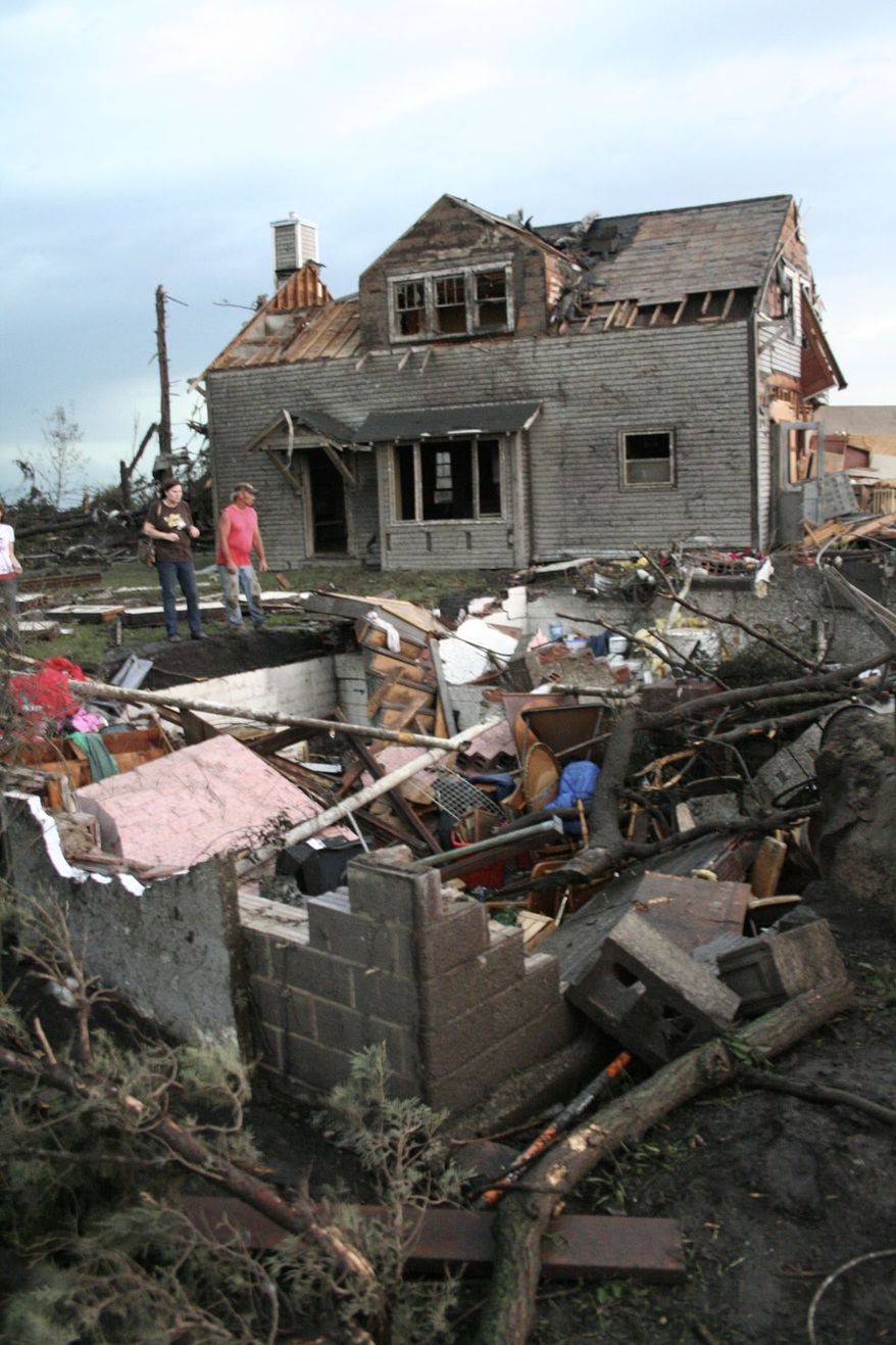 The home of Bob and Laural Hanson is about 50 feet from its foundation, foreground, on Thursday, June 17, 2010 west of Albert Lea, Minn. The couple were not at home when the tornado moved their house. (AP Photo/Tim Engstram/ Albert Lea Tribune)