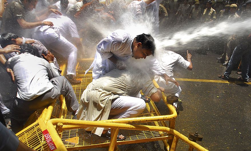Supporters of India&#39;s main opposition Bharatiya Janata Party face a water-canon burst as they protest rise in price of essential commodities and fuel in capital New Delhi on Friday, June 18, 2010. (AP Photo)