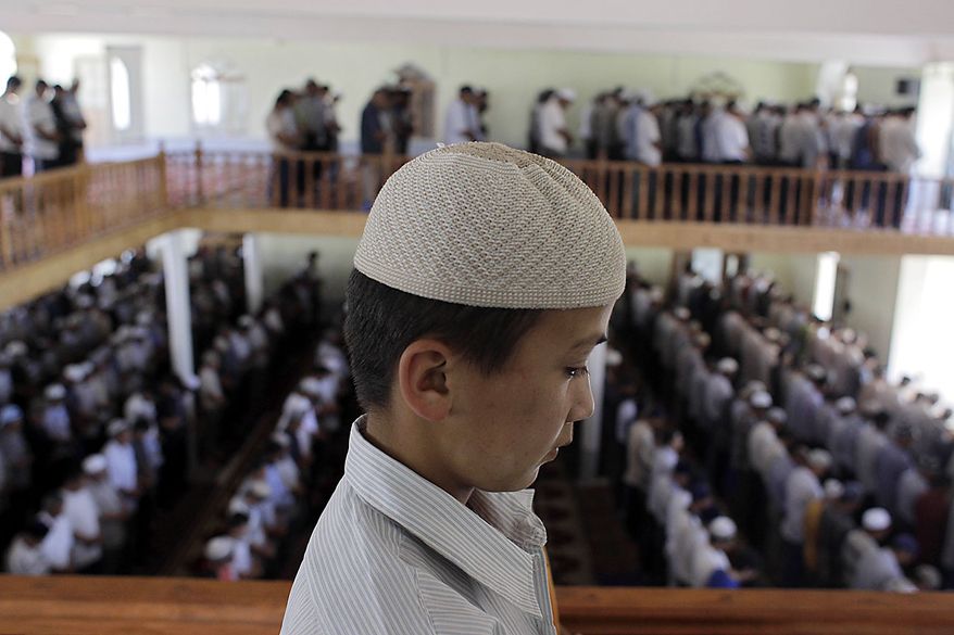 An ethnic Uzbek boy is seen during a Friday prayer in a mosque in Suzak, the Uzbek neighborhood near the southern Kyrgyz city of Jalal-Abad, Kyrgyzstan, Friday, June 18, 2010. Some 400,000 people have been displaced by ethnic violence in southern Kyrgyzstan, the United Nations announced Thursday, dramatically increasing the official estimate of a crisis that has left throngs of desperate, fearful refugees without enough food and water in grim camps along the Uzbek border. (AP Photo/Sergey Ponomarev)