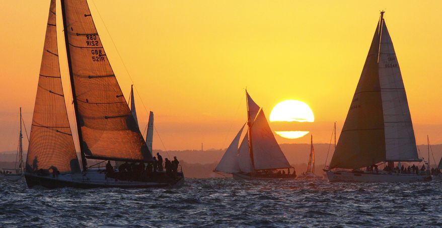 The sun rises before the 5am start during the JP Morgan Asset Management Round the Island Race, with The yacht "Bob" owned by BP Chief Executive Tony Hayward, left, Saturday June 19, 2010, near Cowes, Isle of Wight, off the south coast of England. Spokeswoman Sheila Williams said Hayward took time off his duties handling the environmental catastrophe in the Gulf of Mexico to see his boat participate in Saturday's race. (AP Photo/Chris Ison, PA)