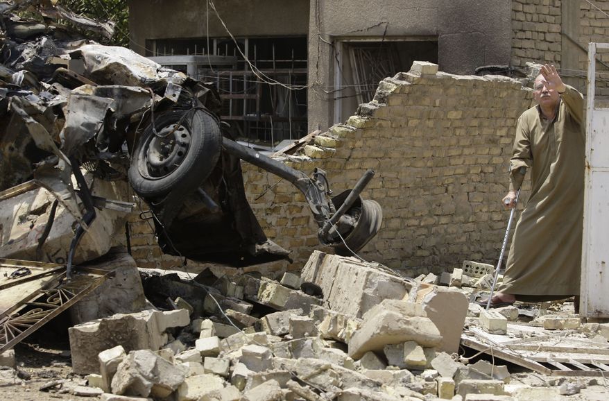 Twin car bombs exploded on Sunday, June 20, 2010, near a major square in Baghdad, killing at least 18 people and wounding dozens in the latest attack targeting a high-profile area in the capital. (AP Photo/Hadi Mizban)