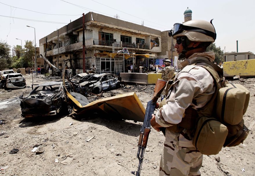 An Iraqi army soldier stands guard at the site of a car bombing in Baghdad on Sunday, June 20, 2010. Twin car bombs exploded Sunday near a major square in the Iraqi capital, killing at least 28 people and wounding dozens in the latest attack targeting a high-profile area in the capital. (AP Photo/Hadi Mizban)