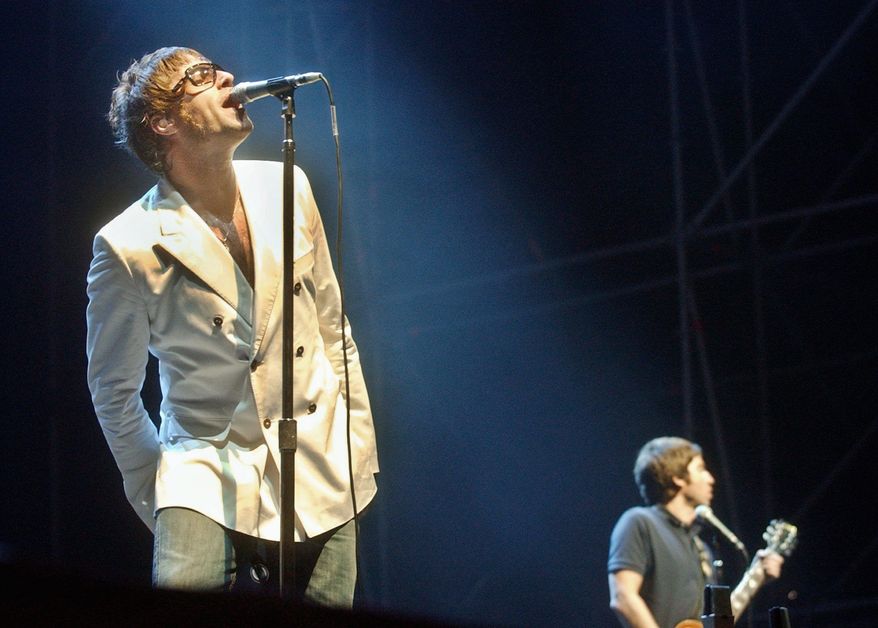 Liam (left) and Noel Gallagher of Oasis perform in 2006. (Associated Press)