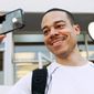 Thomas Smith, 32, of Boston, tries out the video on his new iPhone after standing in line outside the Apple Store in the Georgetown neighborhood of Washington, on Thursday, June 24, 2010. &quot;This is going to be the talk of the office today,&quot; says Smith. (AP Photo/Jacquelyn Martin)
