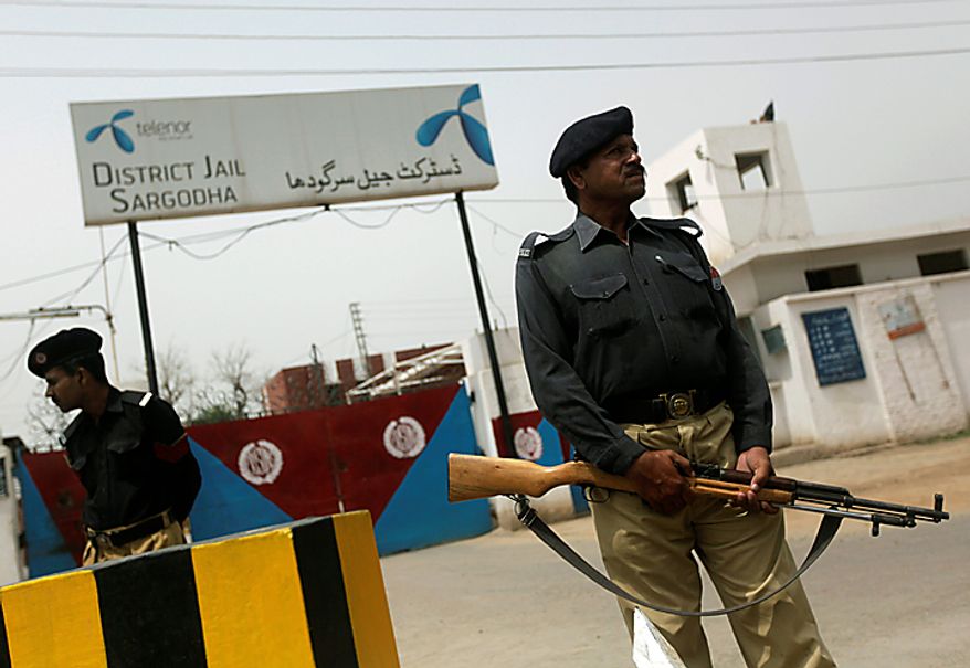 Pakistani police officers stand guard outside the district jail where five young Muslims from the Washington, D.C. area, who were arrested in Pakistan in December, are being held, in Sargodha, Pakistan, Thursday, June 24, 2010. The five American men were convicted Thursday on terror charges by a Pakistan court and sentenced to 15 years in prison each, a prosecutor said. The judge handed down two prison terms for each man, one for 10 years and the other for five, said deputy prosecutor Rana Bakhtiar. (AP Photo/Dita Alangkara)