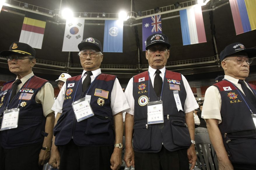 Korean War veterans pay their respects during a ceremony to mark the 60th anniversary of the outbreak of the Korean War in Seoul, South Korea, Friday, June 25, 2010. The two Koreas commemorated the anniversary Friday of the war, promoting vastly different views of the origins of the conflict that still divides their peninsula a full six decades later. (AP Photo/Ahn Young-joon)