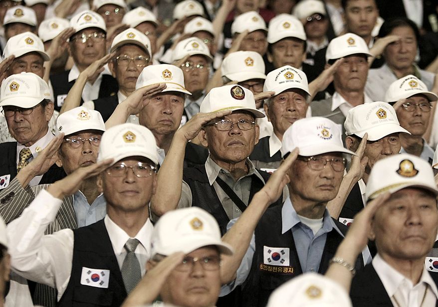 Korean War veterans salute during a ceremony to mark the 60th anniversary of the outbreak of the Korean War in Seoul, South Korea, Friday, June 25, 2010. The two Koreas commemorated the anniversary Friday of the war, promoting vastly different views of the origins of the conflict that still divides their peninsula a full six decades later. (AP Photo/Ahn Young-joon)