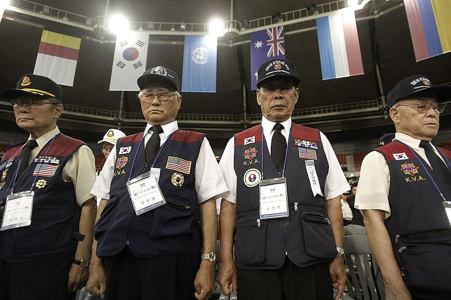 Korean War veterans pay their respects during a ceremony to mark the 60th anniversary of the outbreak of the Korean War in Seoul, South Korea, Friday, June 25, 2010. The two Koreas commemorated the anniversary Friday of the war, promoting vastly different views of the origins of the conflict that still divides their peninsula a full six decades later. (AP Photo/Ahn Young-joon)