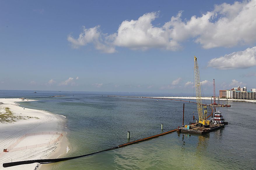 Booming operations continue across the Perdido Pass in Orange Beach, Ala., Friday, June 25, 2010. Oil from the Deepwater Horizon disaster continues to wash ashore along the Alabama and Florida coasts. (AP Photo/Dave Martin)