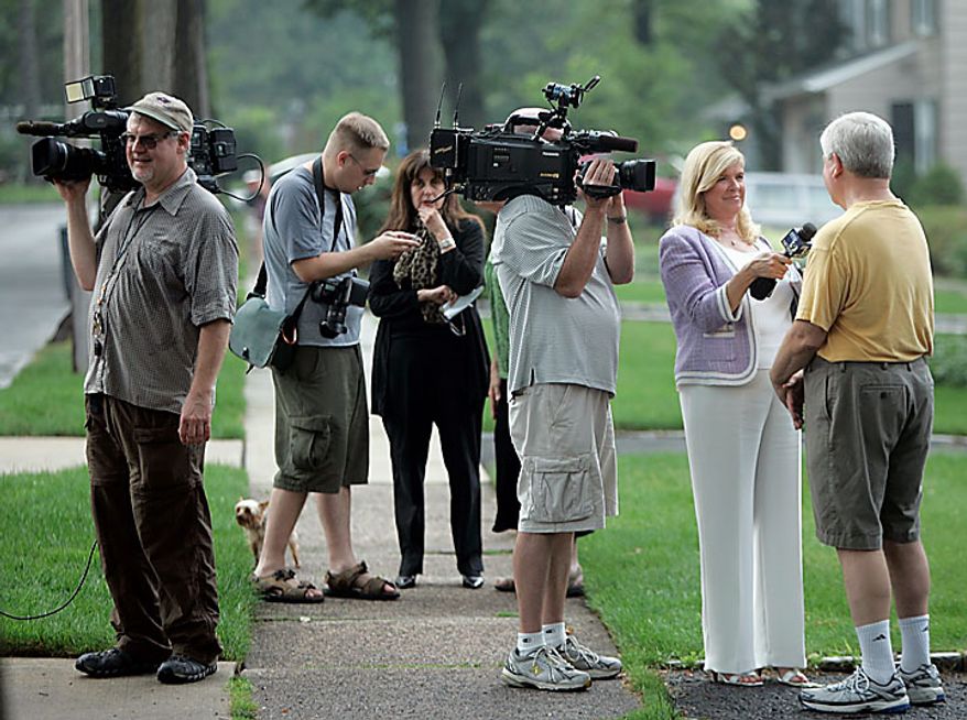Neighbors are interviewed on Marquette Road in Montclair, N.J., on Monday, July 28, 2010. Their neighbors, "Richard Murphy" and "Cynthia Murphy" were arrested by the FBI at their house on Sunday. (AP Photo/Rich Schultz)