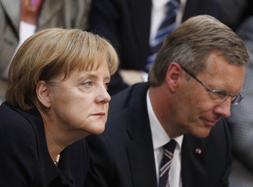 German Chancellor Angela Merkel and Christian Wulff, presidential candidate of the ruling German coalition, react prior to the election of the new German President during the Federal Assembly in the Berlin at the Reichstag parliament building, Wednesday, June 30, 2010. The Federal Assembly had to elect a new president after President Horst Koehler's resignation on May 31, 2010. (AP Photo/Markus Schreiber)