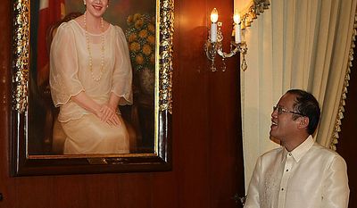 New Philippine President Benigno Aquino III looks at a portrait of his late mother, former President Corazon Aquino, at the presidential palace in Manila, Philippines, Wednesday, June 30, 2010. Aquino was sworn in Wednesday as the Philippines&#39; 15th president, leading a Southeast Asian nation his late parents helped liberate from dictatorship and which he promises to deliver from poverty and pervasive corruption. (AP Photo/Rolex dela Pena, Pool)