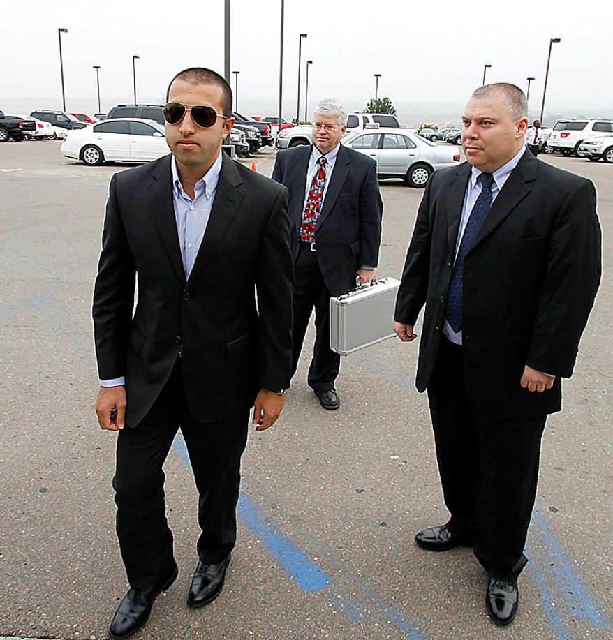 Mosab Hassan Yousef, left,, walks into his deportation hearing with his attorney Steven Seick, center, and former Israeli security service agent Gonen Ben-Itzhak, right, at the immigration detention center in San Diego Wednesday, June 30, 2010. Yousef says he will be killed if he is deported from the United States to the West Bank. The oldest son of one of Hamas' founders, he was an Israeli spy for a decade, and he abandoned Islam for Christianity, further marking him a traitor. (AP Photo/Denis Poroy)